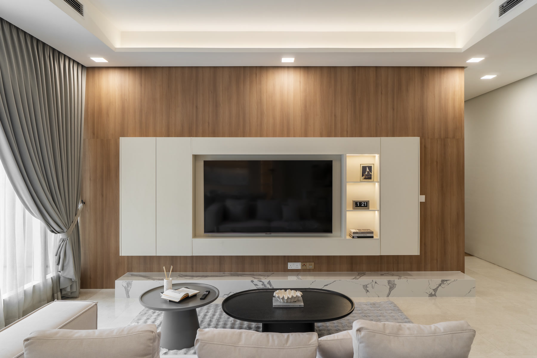 Living room with timber wall and built-in television cabinet at Quadro Residences, KLCC