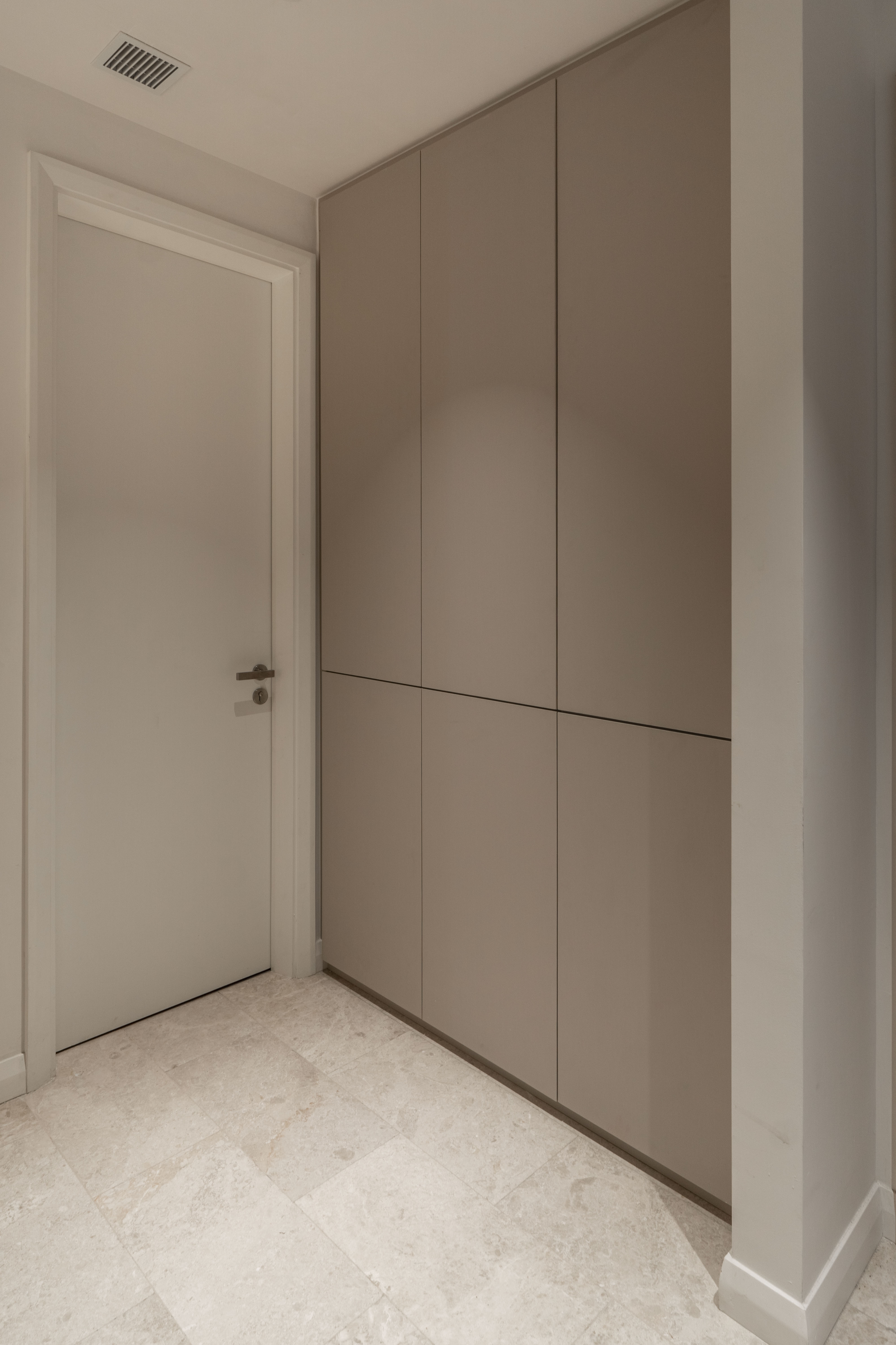 Full-height storage cabinets beside the entrance door at TRX Residence, Unit 01