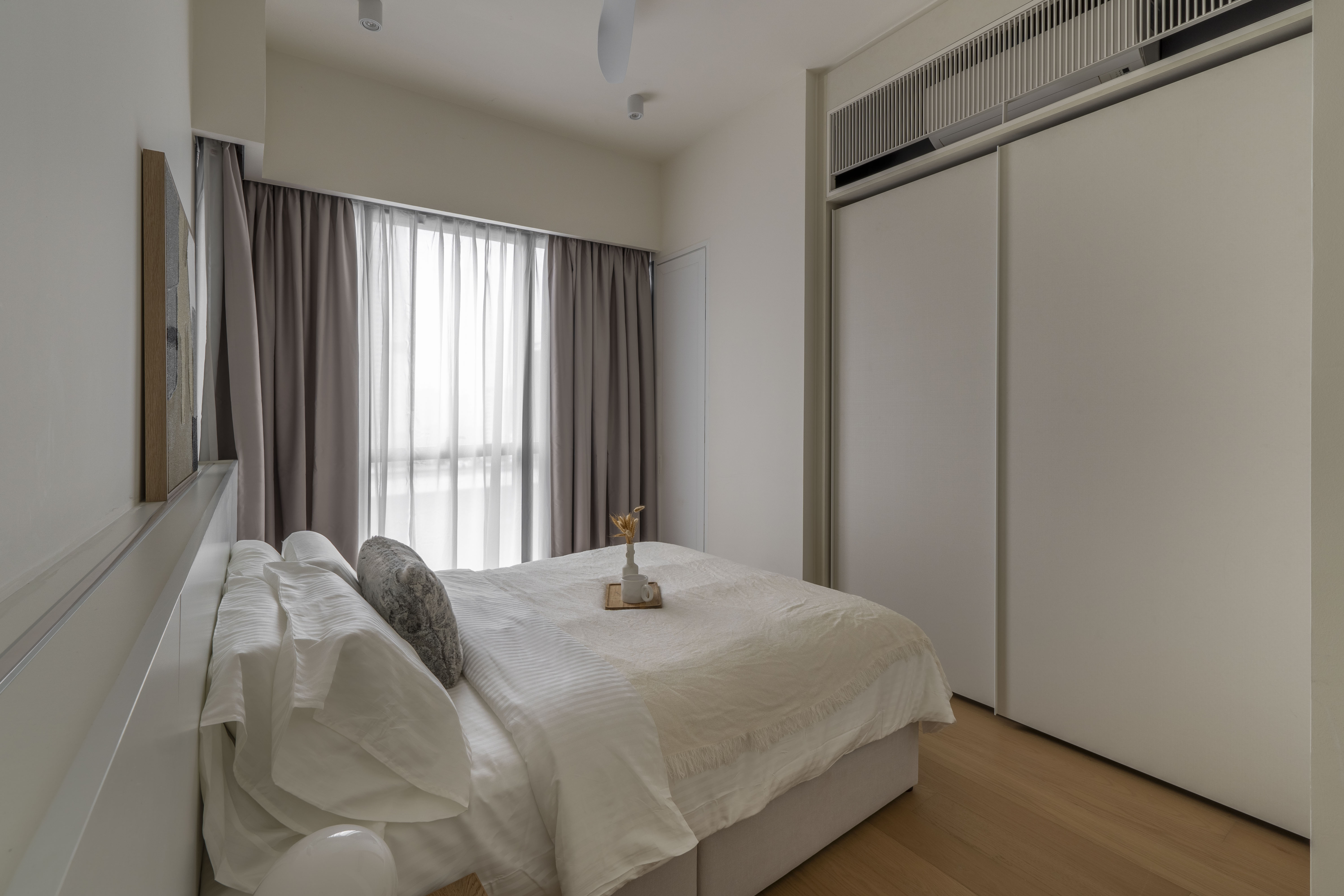 Bedroom beside full-height curtains and a built-in wardrobe at TRX Residence, Unit 01