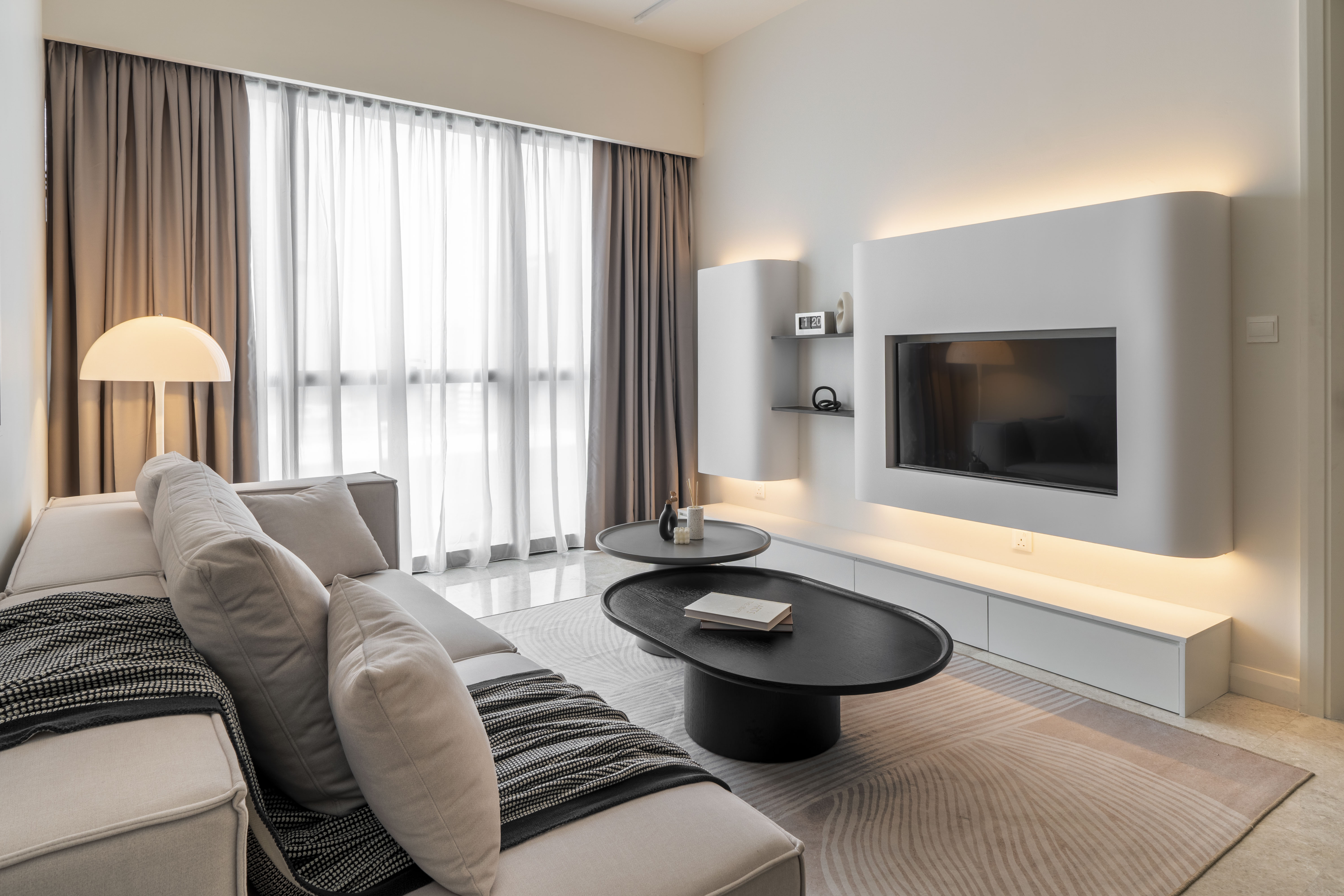 View from the sofa towards the illuminated television wall at TRX Residence, Unit 01