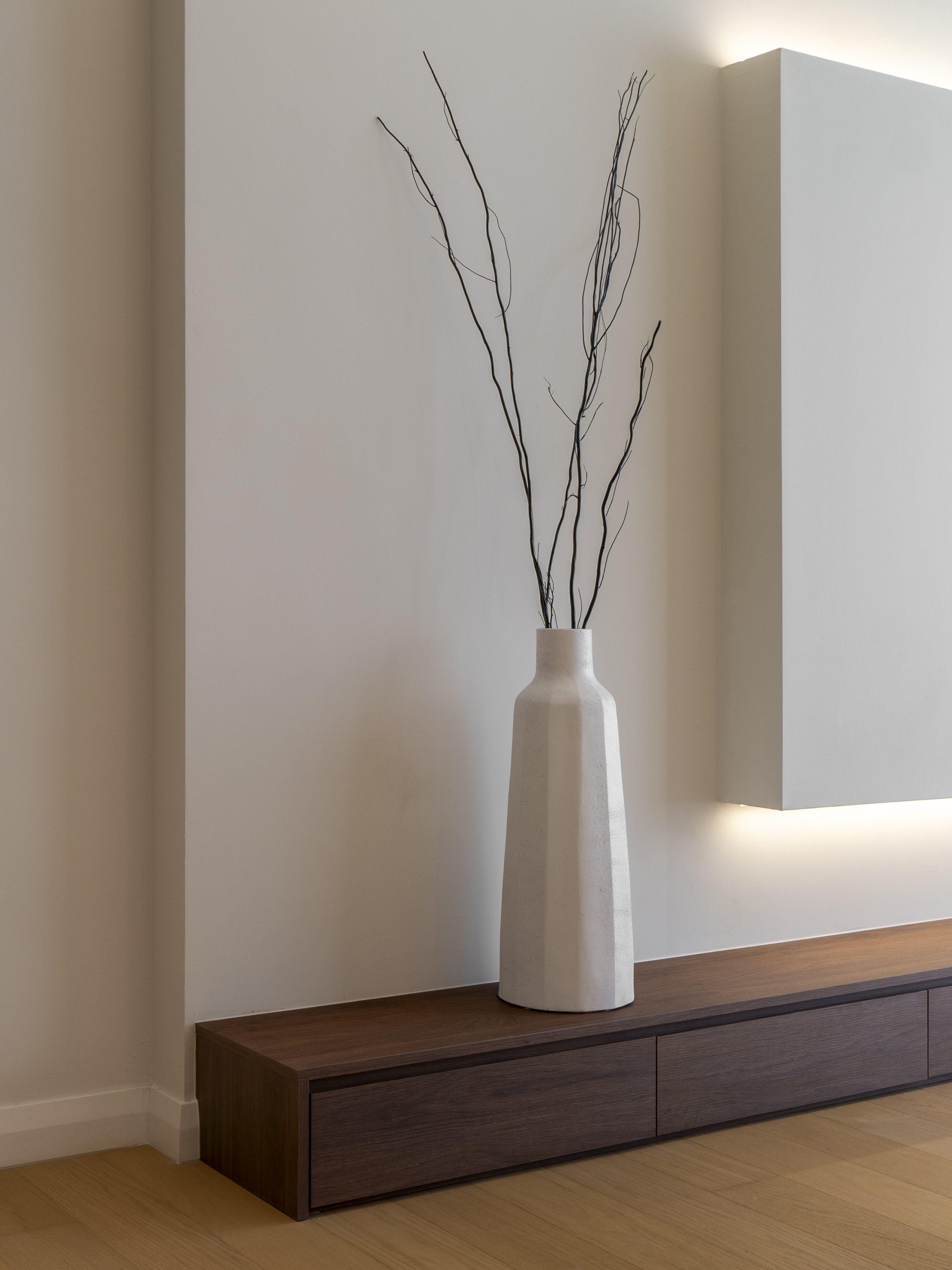 Vase and low TV console in the living room at TRX Residence, Unit 02