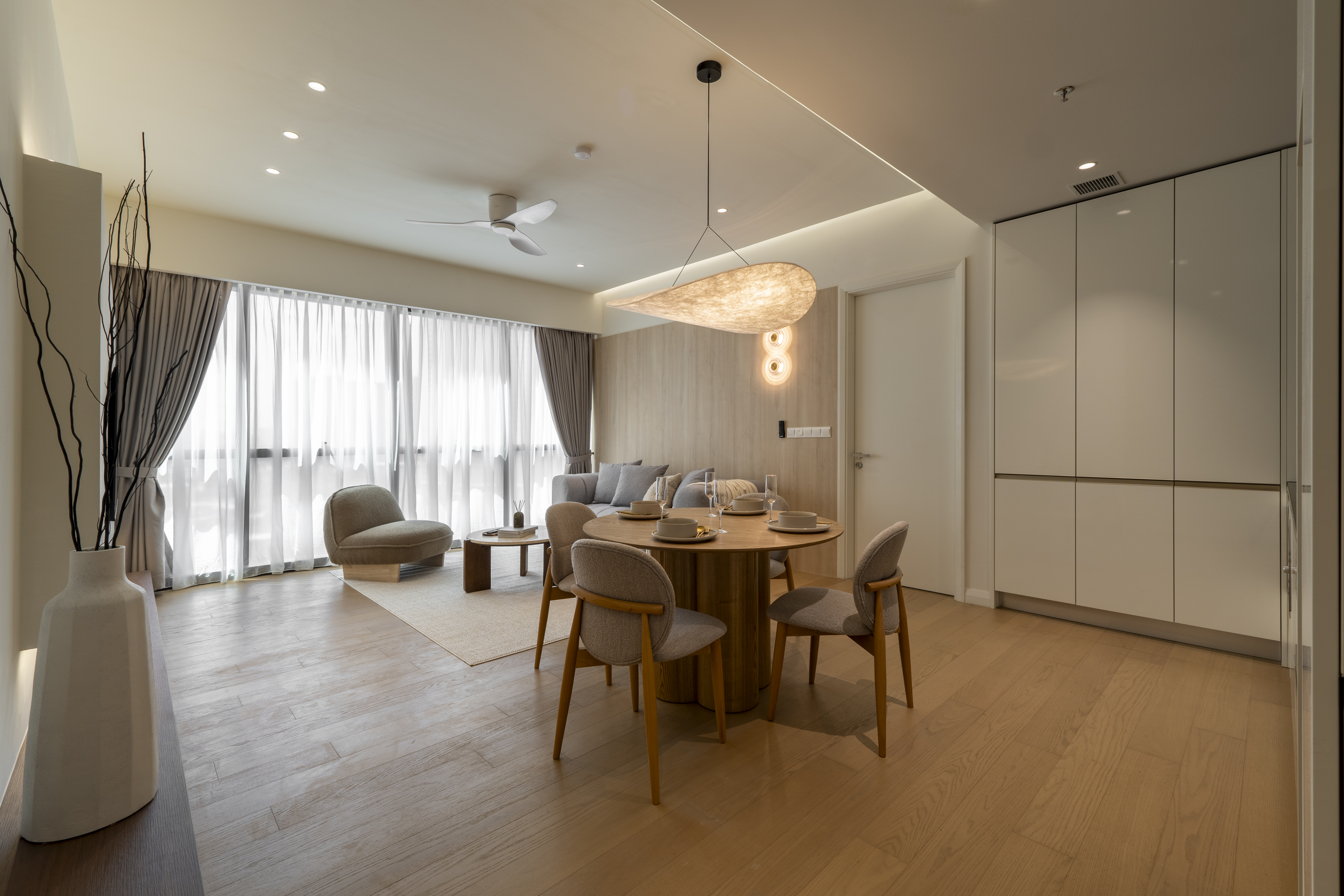 Open-plan dining and living space with full-height storage at TRX Residence, Unit 02