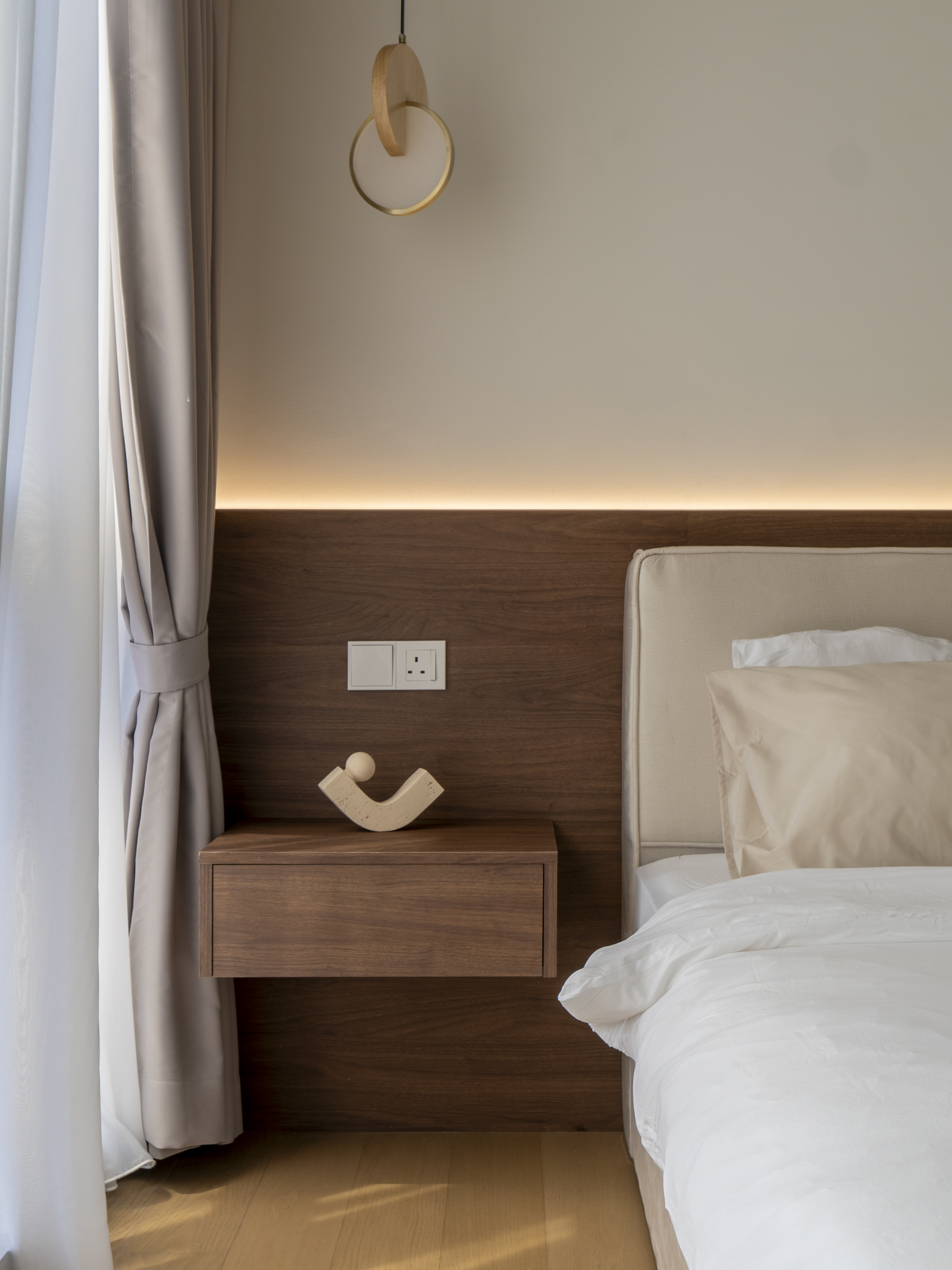 Bedside shelf and pendant light beside the timber headboard at TRX Residence, Unit 02