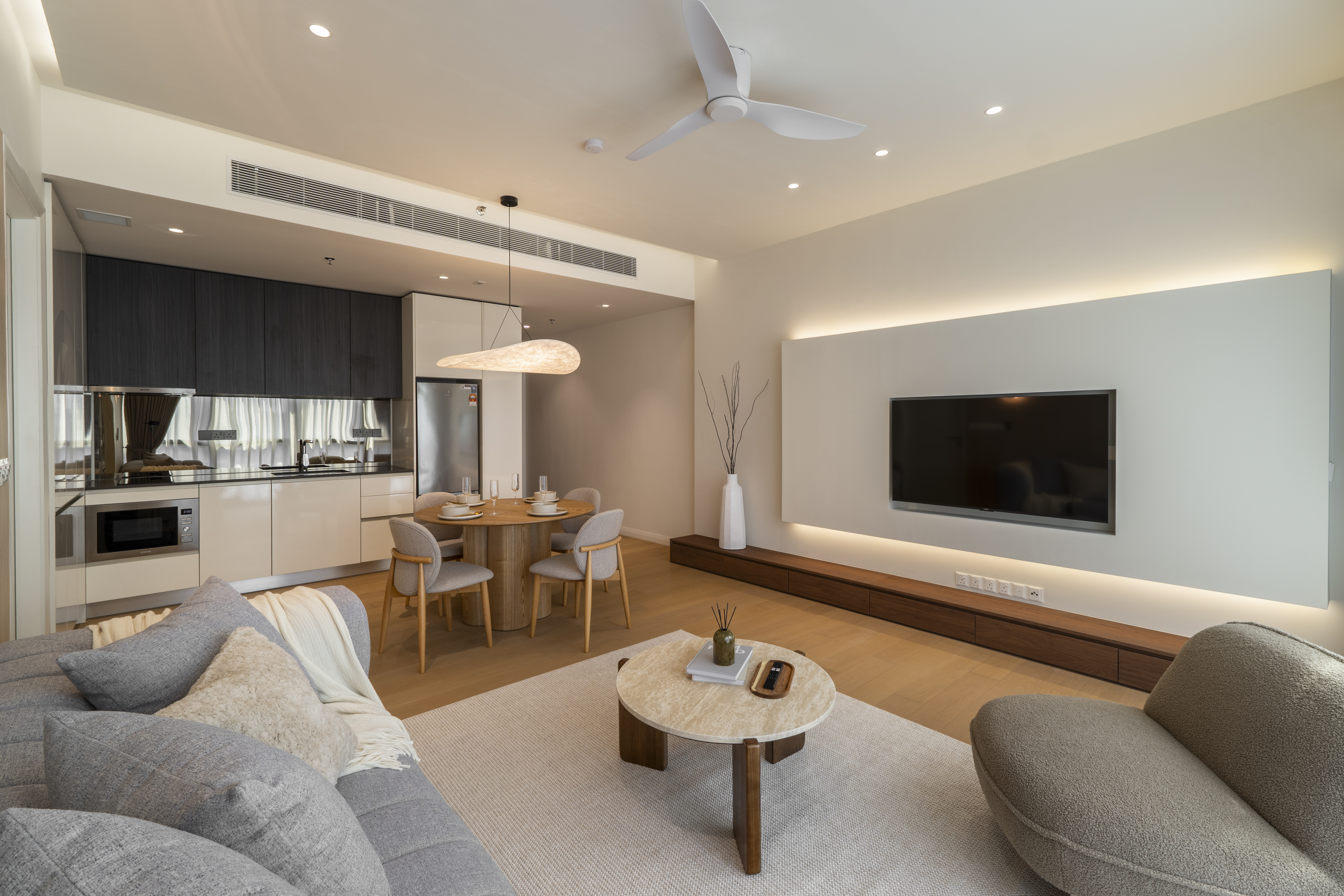 View from the sofa across the living room to the kitchen at TRX Residence, Unit 02