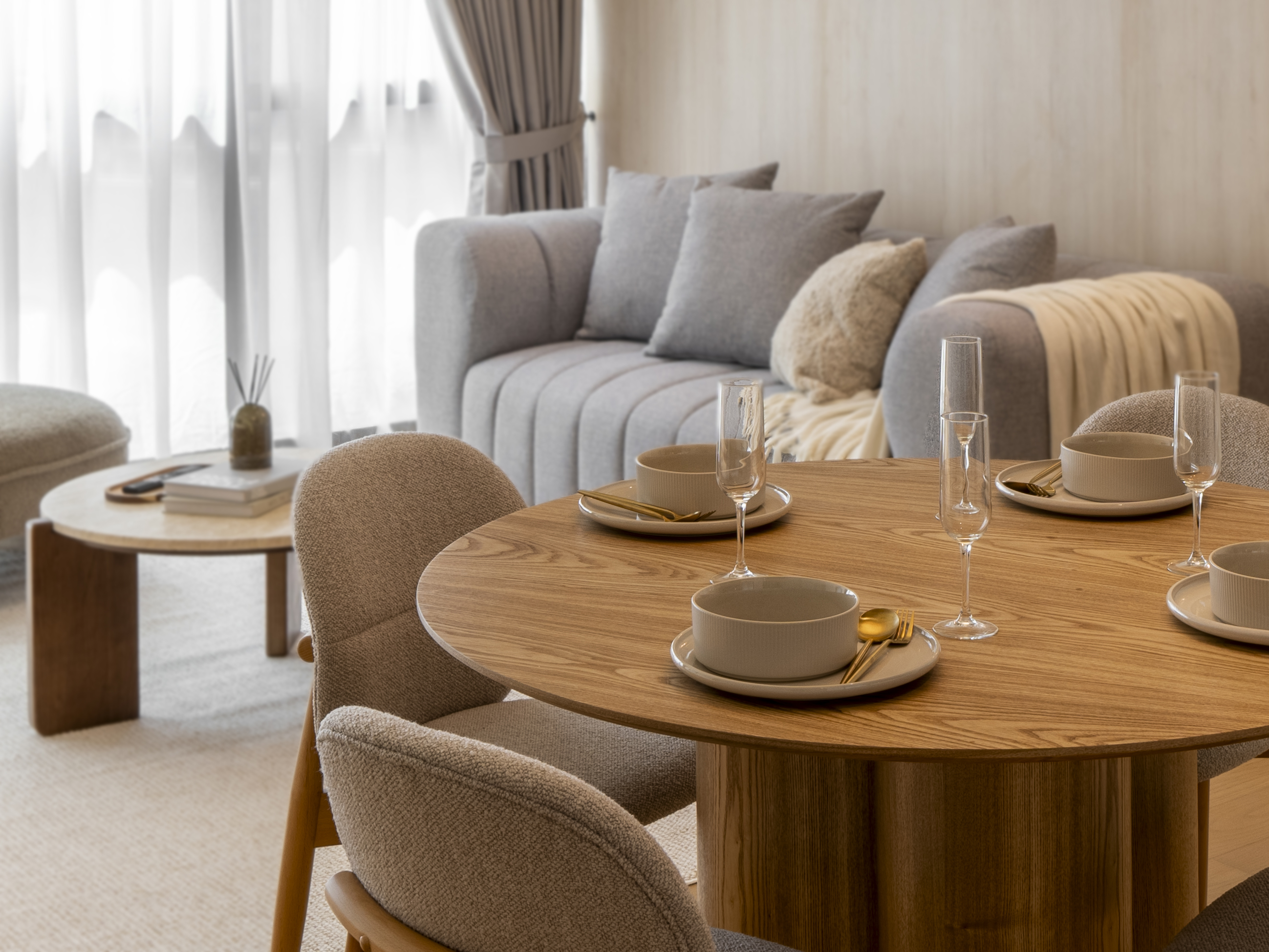 Table setting with curved upholstered dining chairs at TRX Residence, Unit 02
