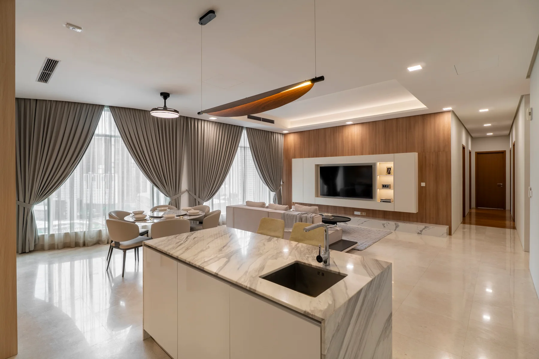 After: Quadro living and dining area with timber TV wall, built-in display shelves and neutral seating